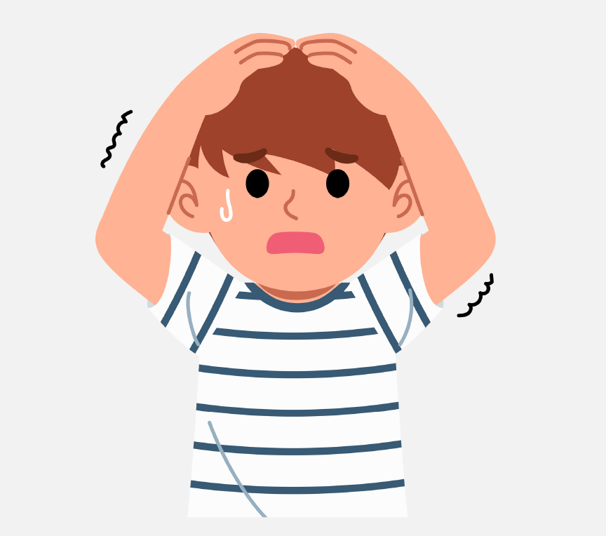 A young, sad boy with his hands on top of his head.