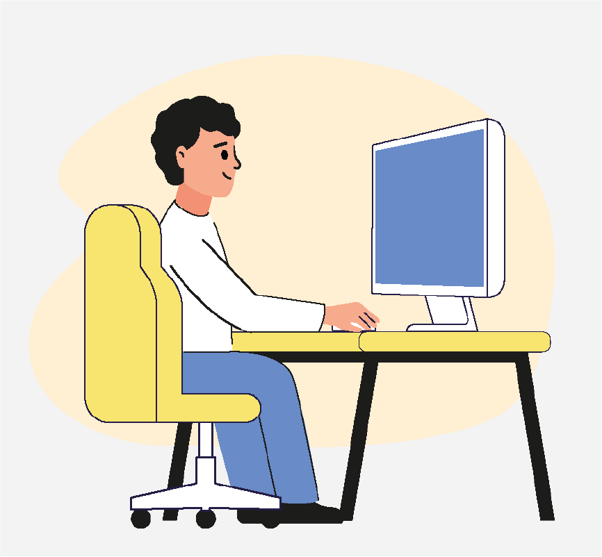 A boy sitting at a desk and looking at a computer screen.