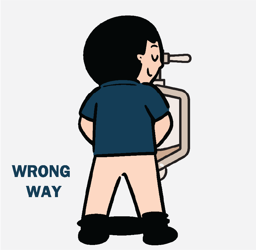 A man using a urinal with his pants all the way down to his ankles. It says 