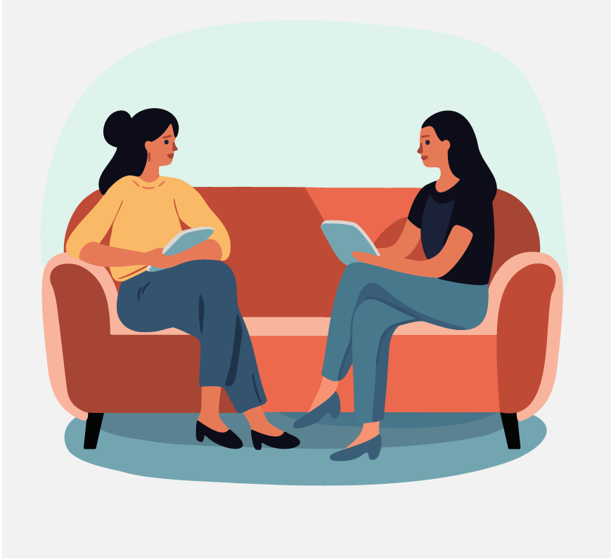 Two women sitting across from each other on an orange couch.