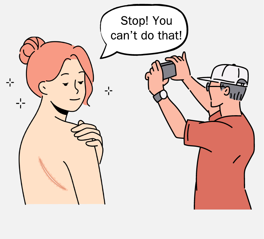 A man is taking a picture of topless woman who is trying to cover herself. She is saying, 
