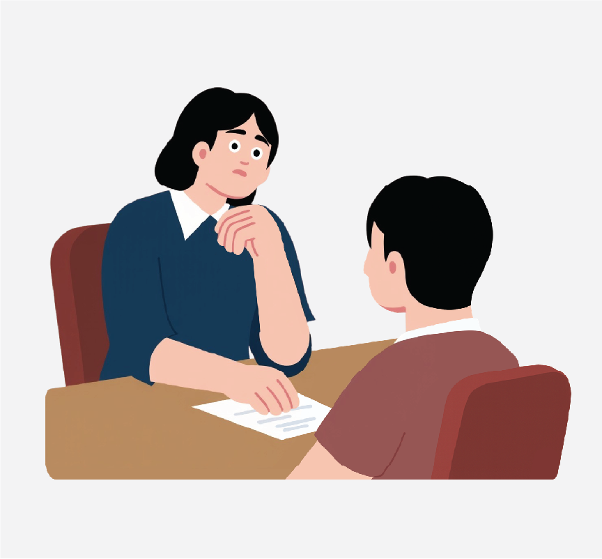 A woman sitting at a desk with a paper and talking to another person across from her.