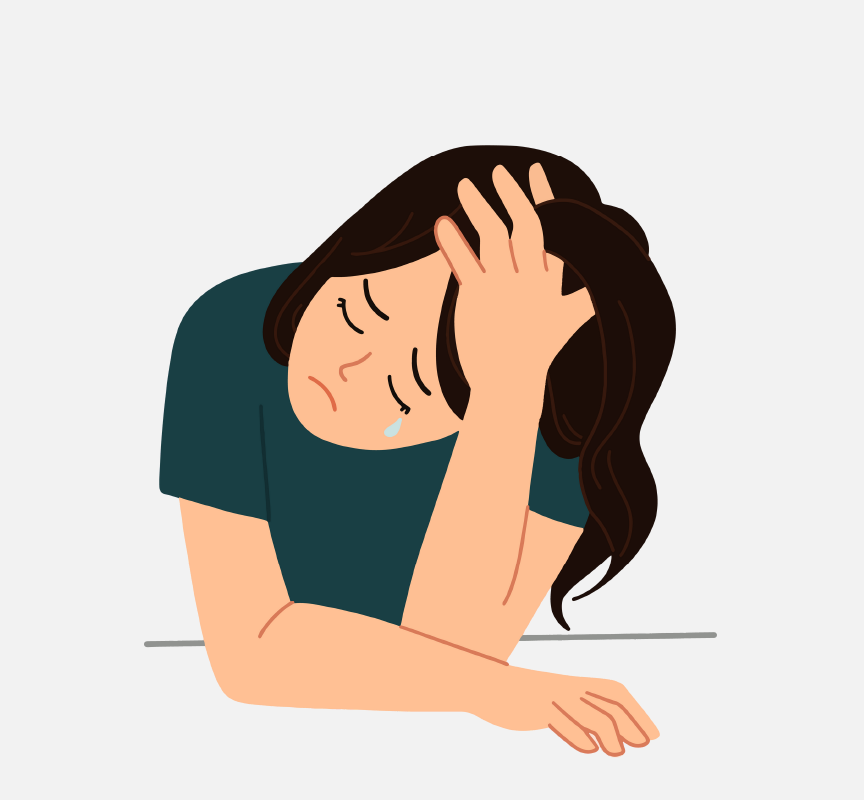 A sad girl with her head on her hand.