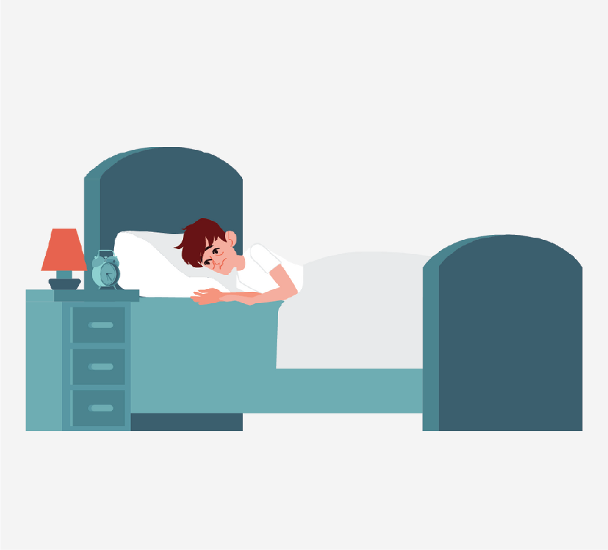 A man lying in a bed. He looks tired.