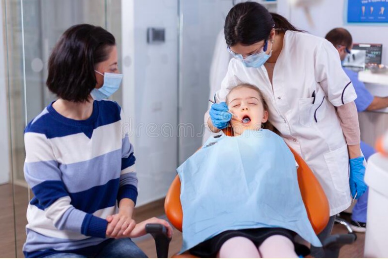 A girl sitting in a dental chair.