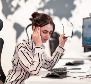 Beautiful Shocked and Annoyed Young Woman Looking at her Laptop. Sad Operator Agent Woman Working from Home in a Call Center. High-quality photo