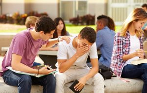 Male High School Student Comforting Unhappy Friend