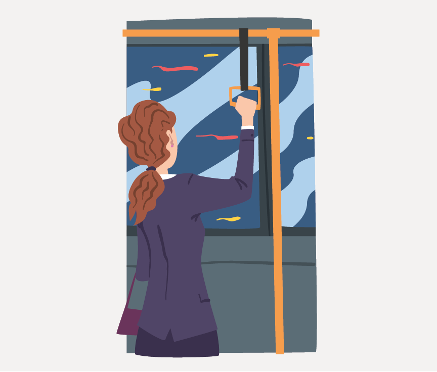 A women standing on a bus holding the hand grips.