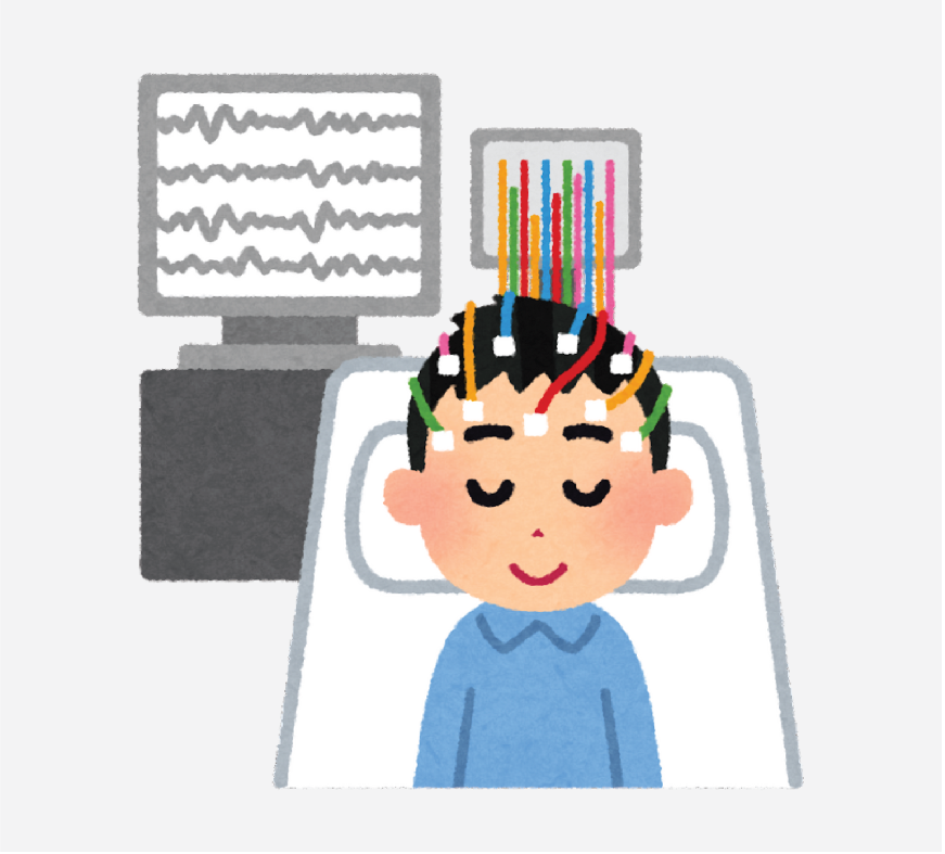 Graphic of a boy with electrodes and wires on his head. There is a computer monitor in the background that is graphing the patient's vital signs.