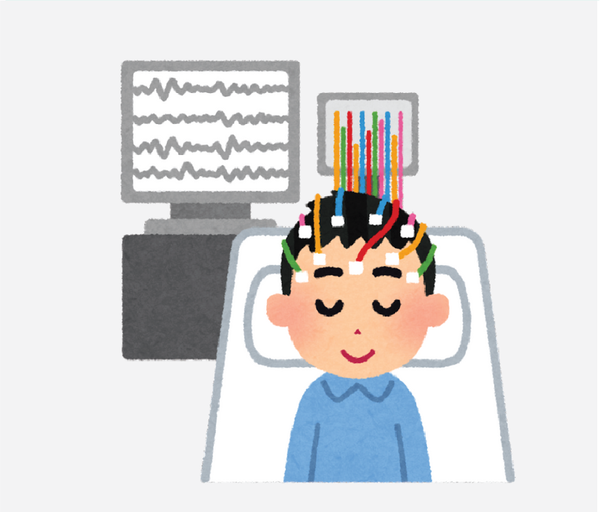 Graphic of a boy with electrodes and wires on his head, there is a monitor in the background that is graphing the vital signs.