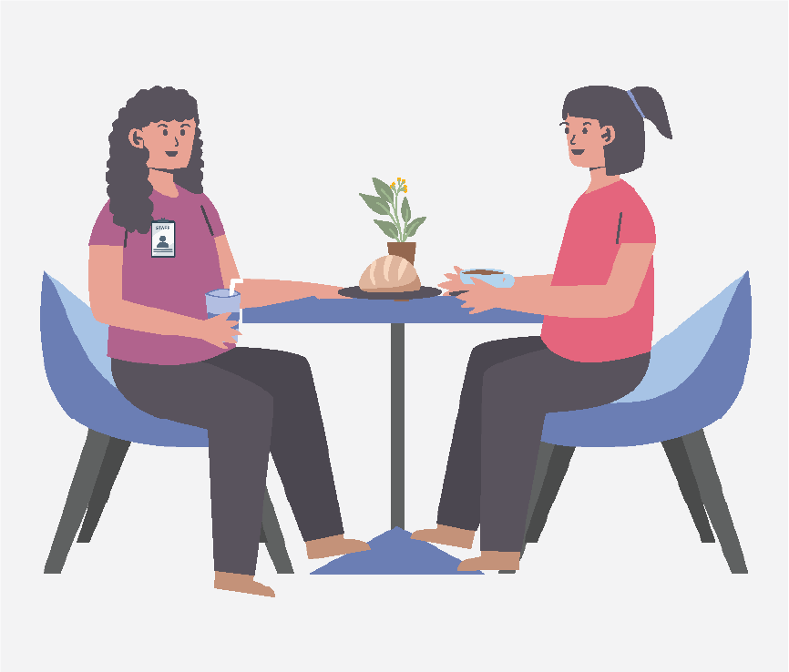 Two women sitting a table together.